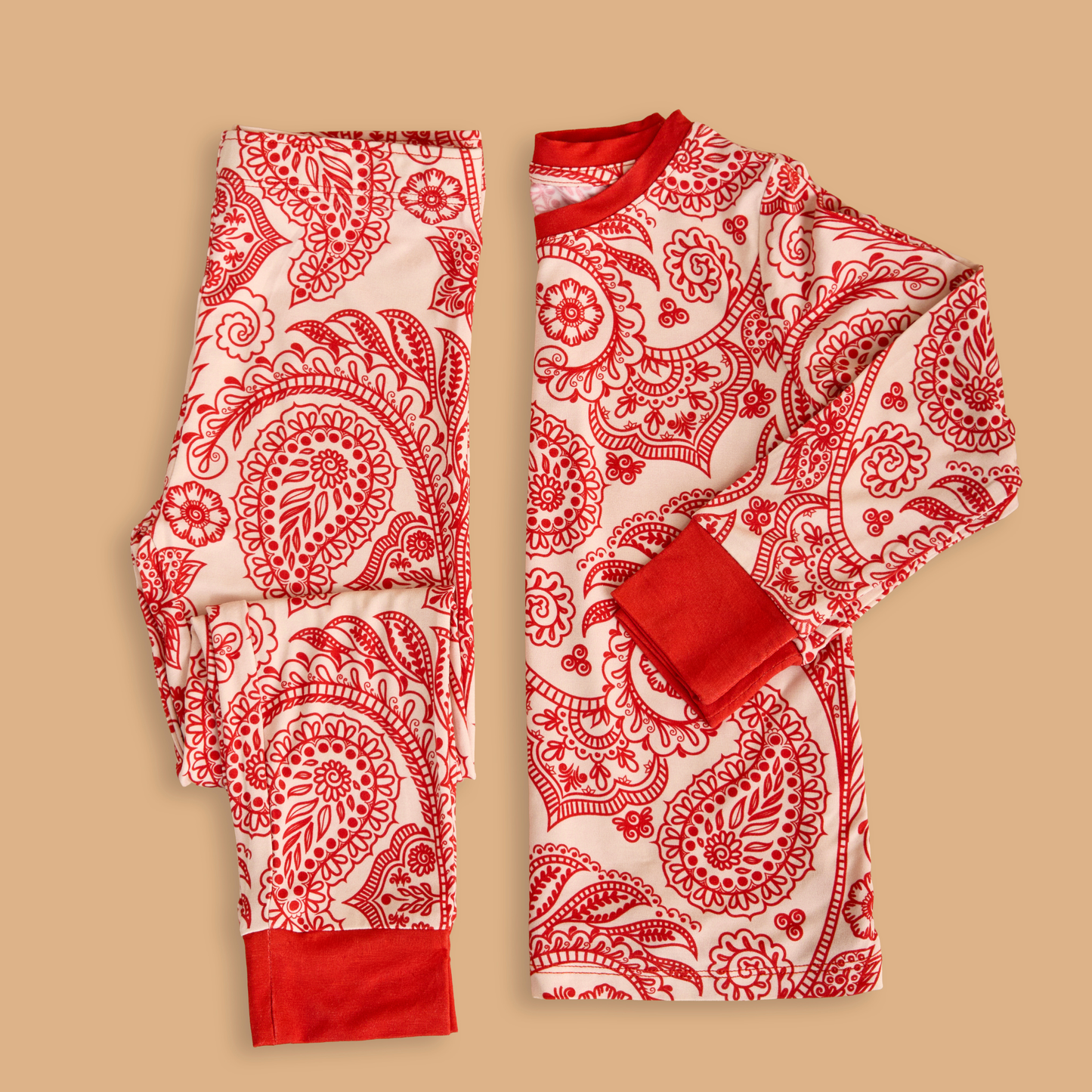 Red and white patterned pajama set on a beige background