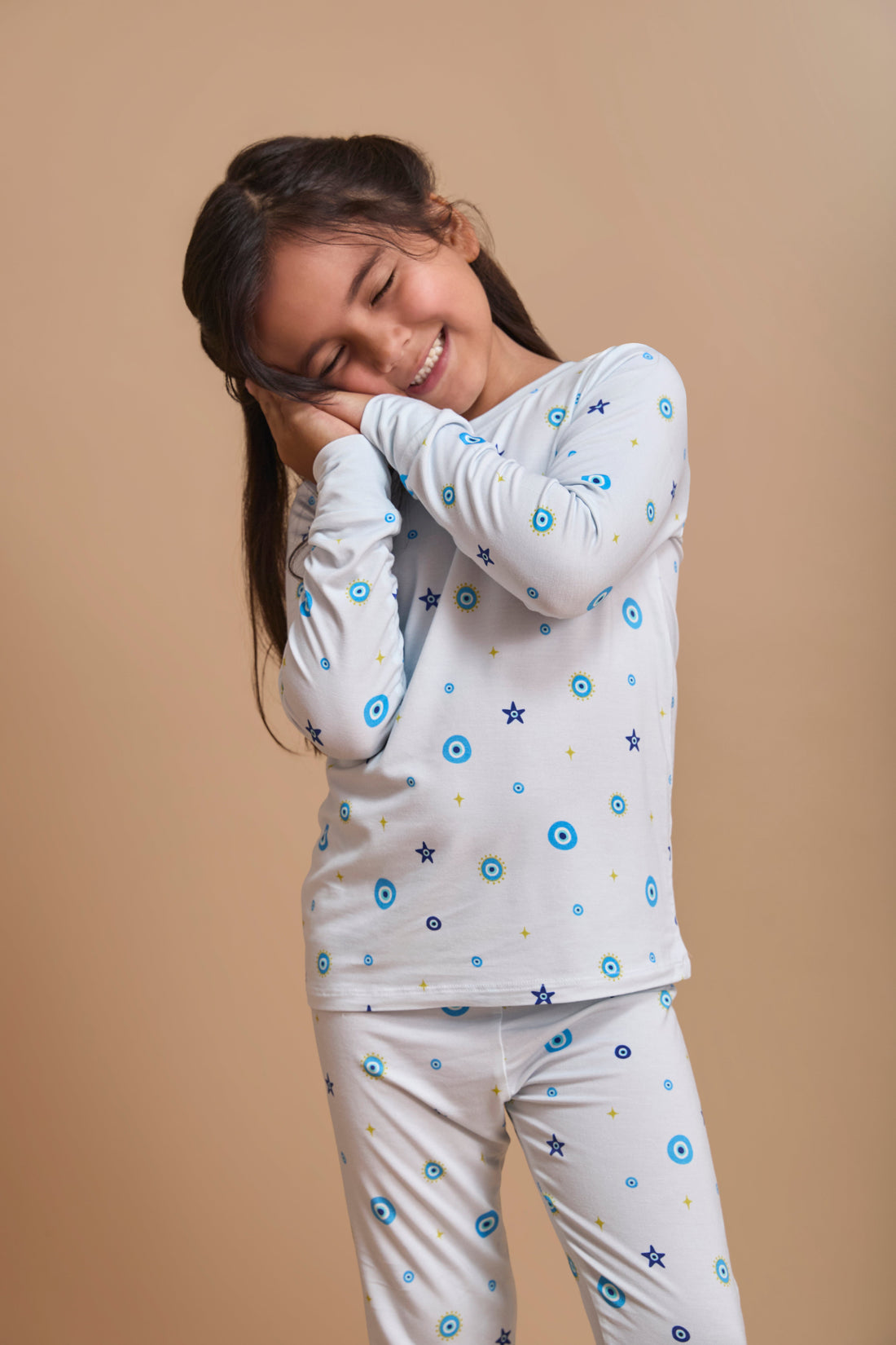 Baby in Nazar Nights bamboo pajamas with traditional South Asian evil eye motifs