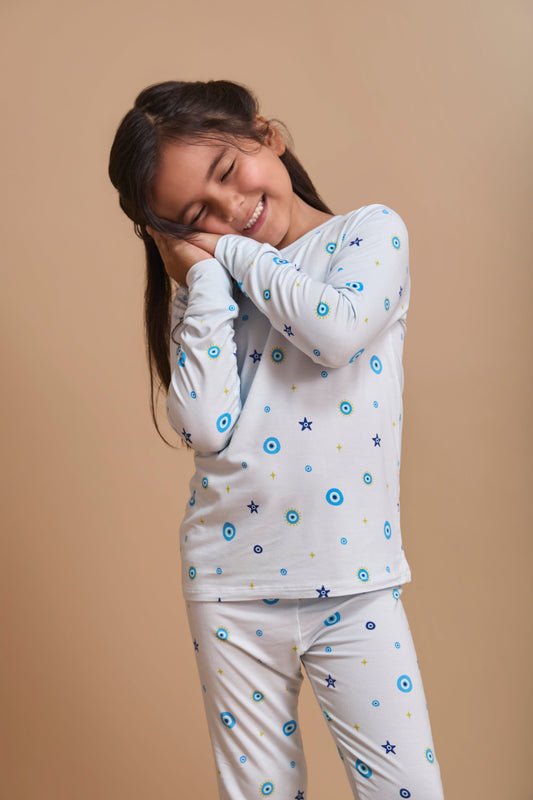 Baby in Nazar Nights bamboo pajamas with traditional South Asian evil eye motifs