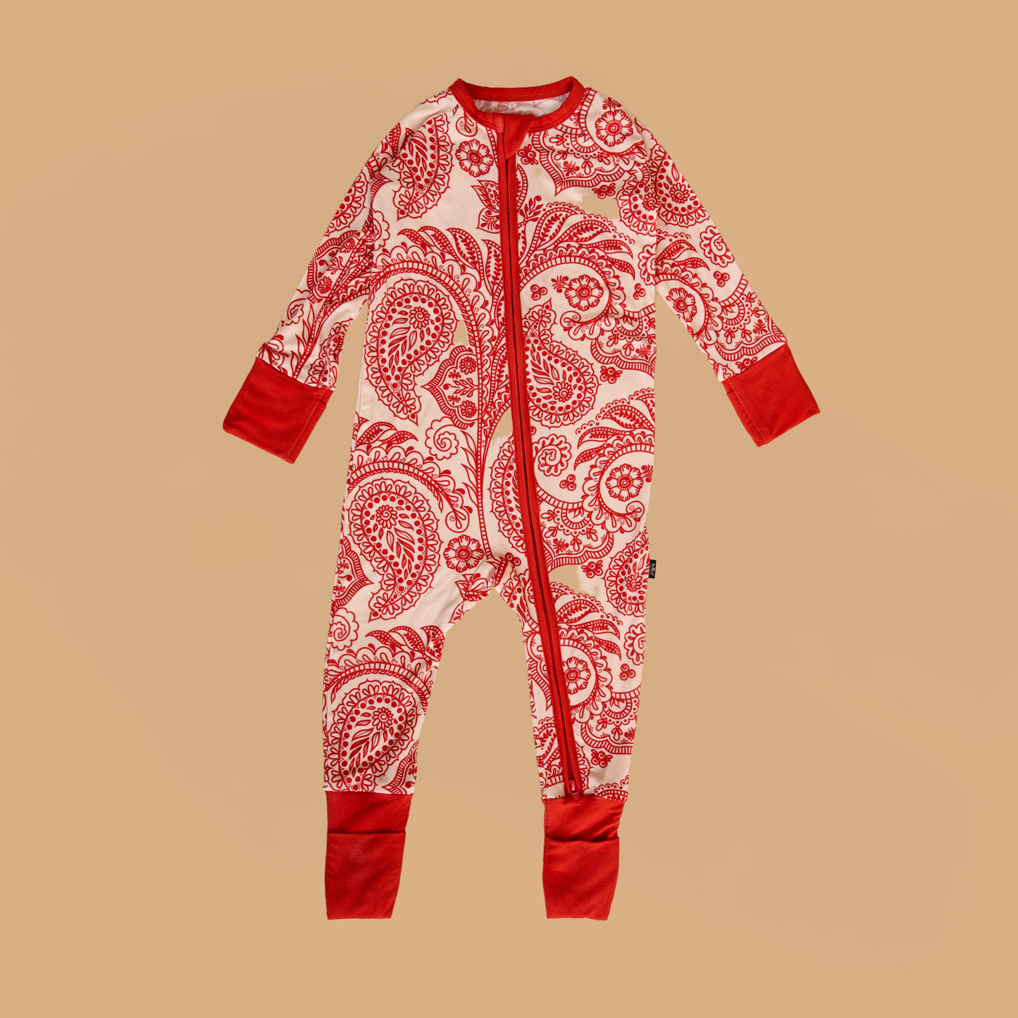 Red and white patterned onesie on a beige background