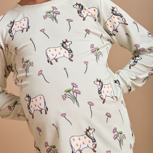 White shirt with cow and flower pattern on a beige background