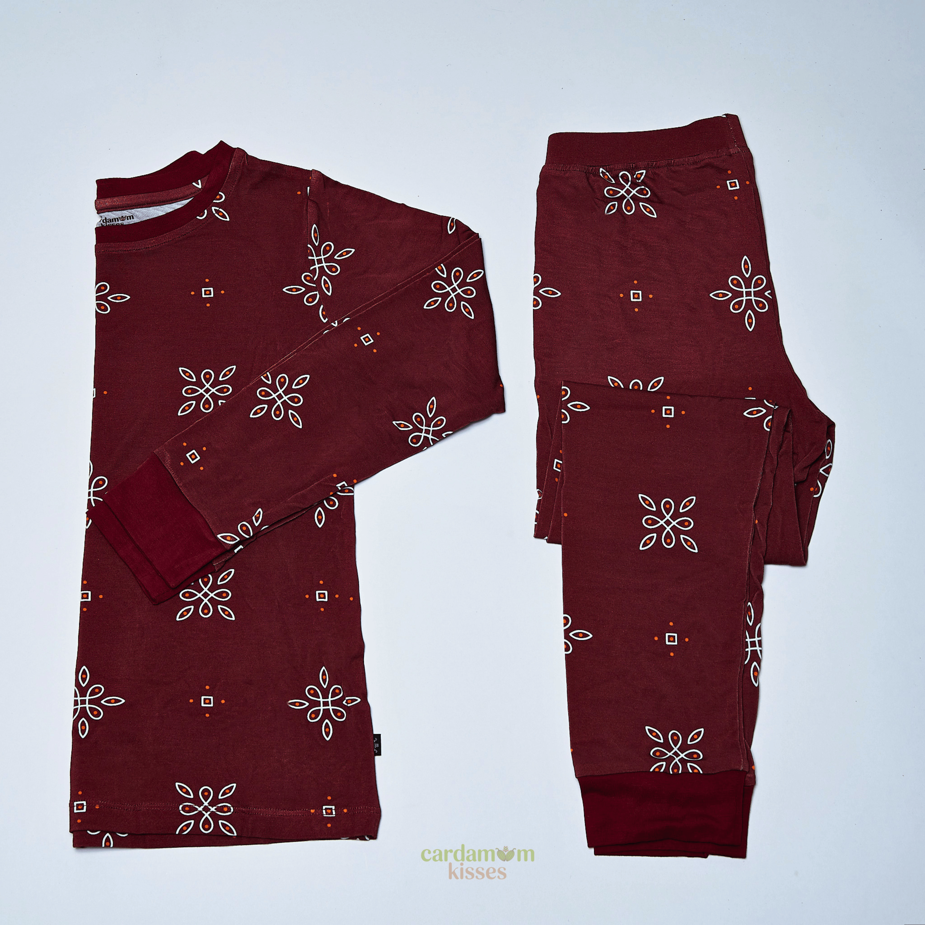 Kolam Kaleidoscope toddler pajama set with geometric print on a beige background