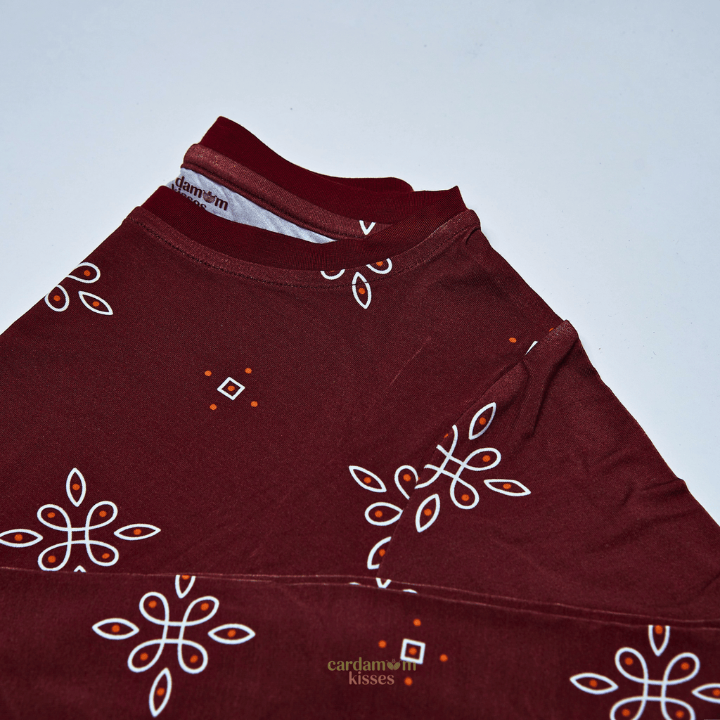 Child wearing a Kolam Kaleidoscope bamboo pajama set on a beige background