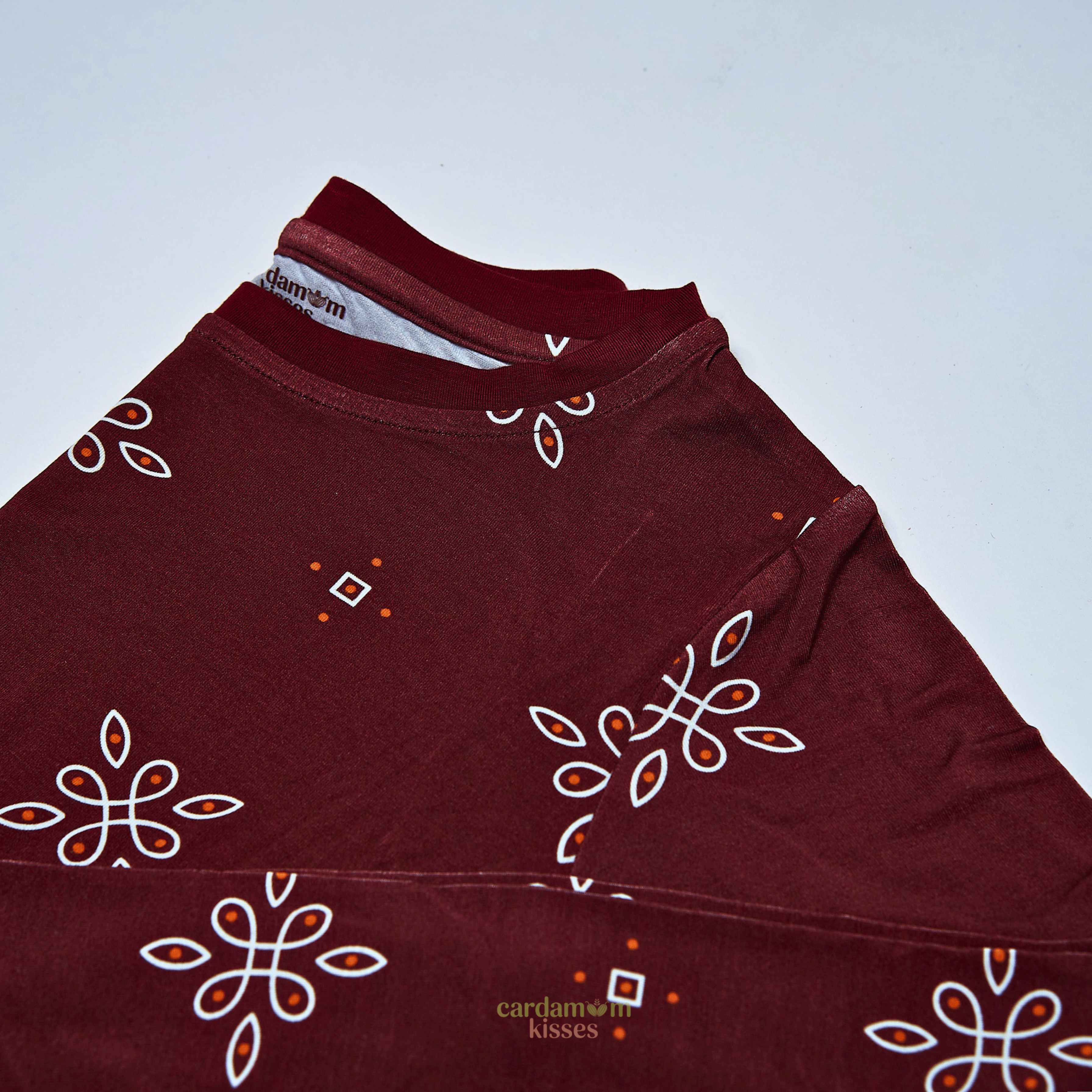 Child wearing a Kolam Kaleidoscope bamboo pajama set on a beige background