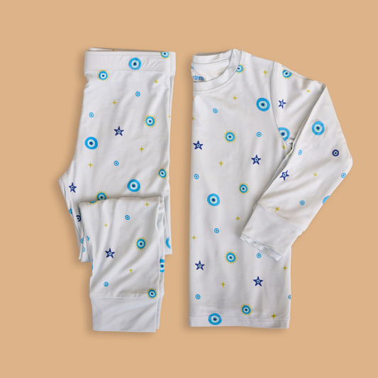 Children's long-sleeve shirt and pants with colorful patterns on a beige background