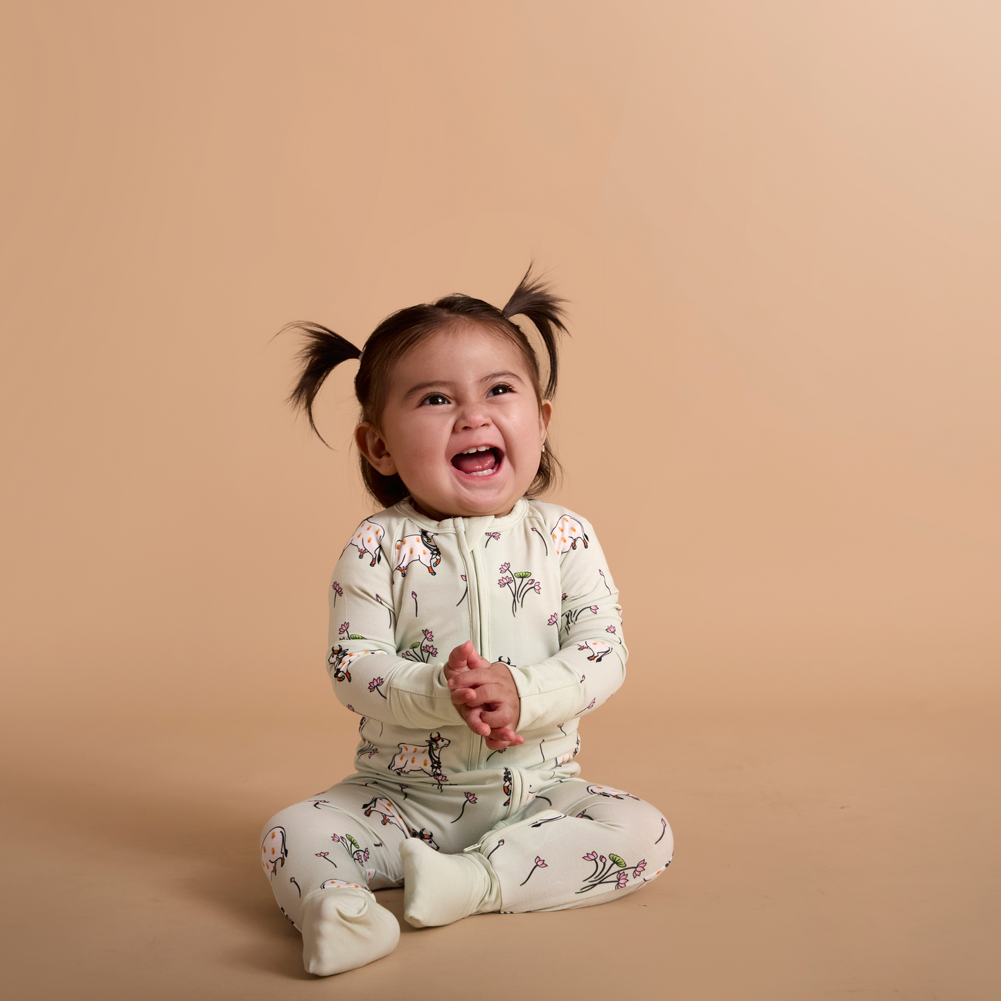 Child wearing a floral outfit on a beige background