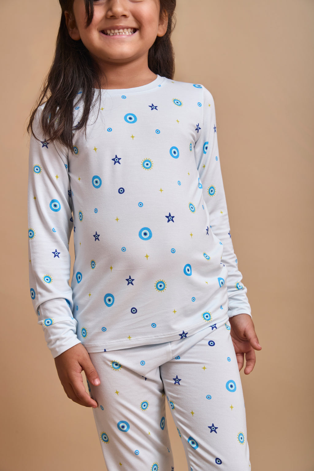 Nazar Nights toddler pajama set with evil-eye print on a beige background