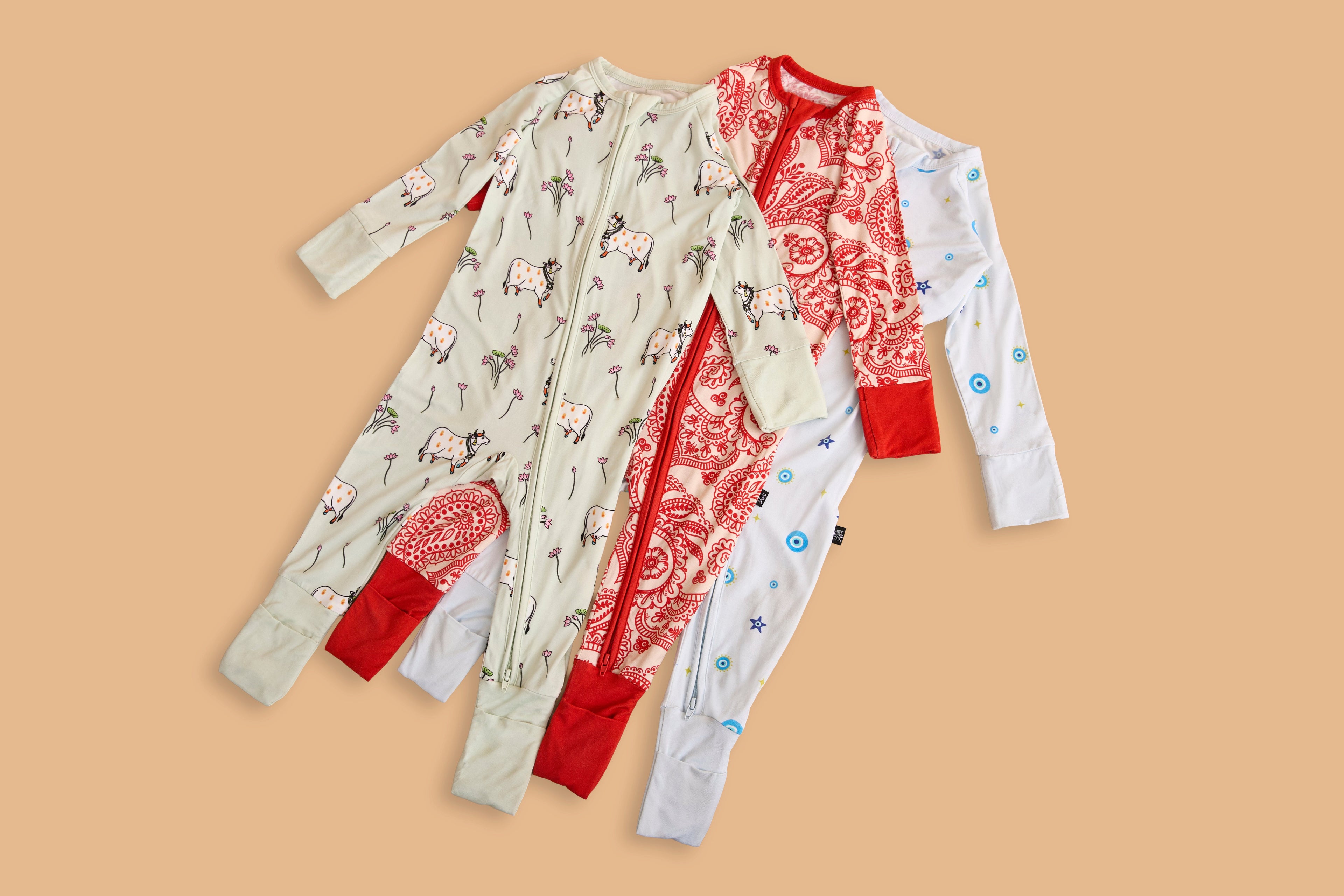 Baby wearing a Cardamom Kisses bamboo zippered sleeper, part of the build-your-own baby bundle