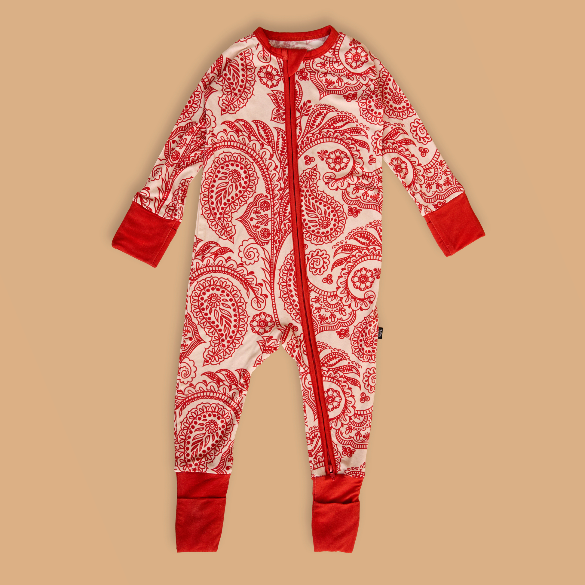 Red and white patterned onesie on a beige background