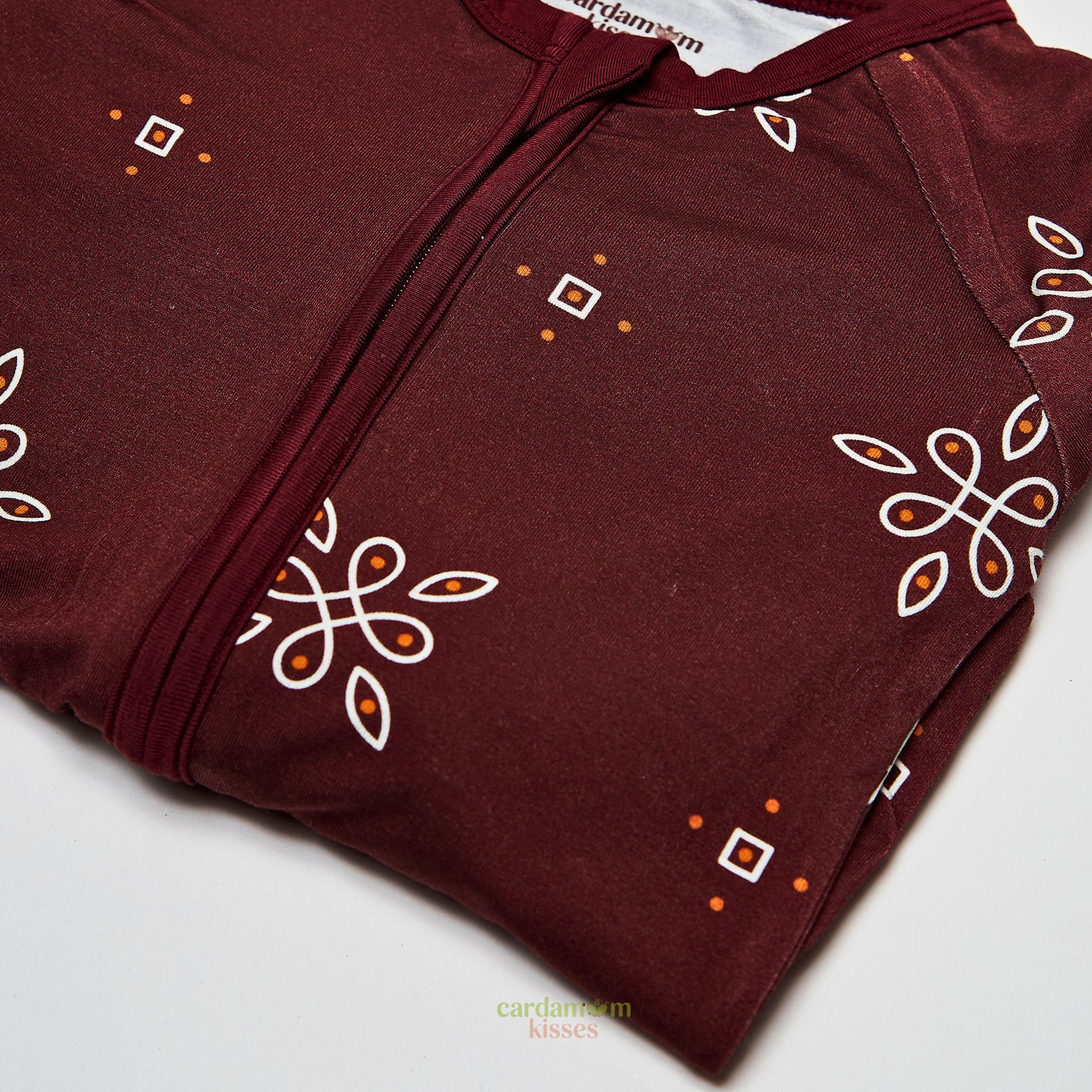 Close-up of Kolam Kaleidoscope print on bamboo baby sleeper fabric